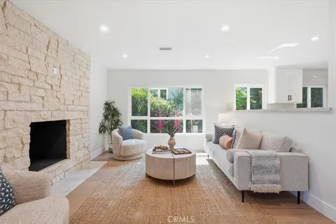 a living room with furniture fireplace and window
