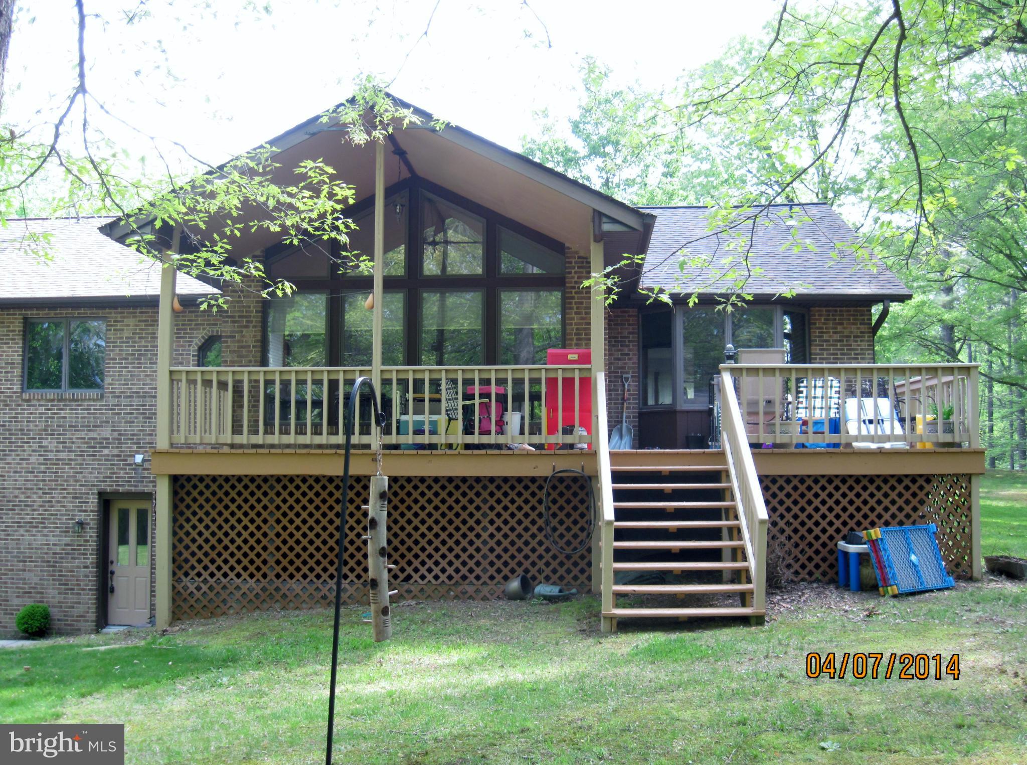 7151 Marshall Road St. Leonard, MD 20685 - Photo 2 of 25 a front view of a house with a garden