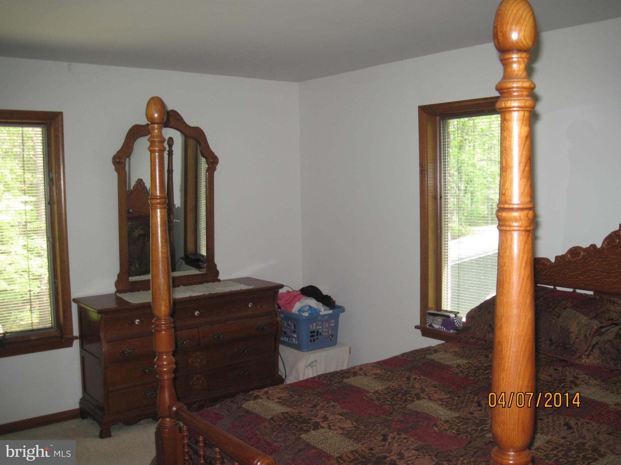 7151 Marshall Road St. Leonard, MD 20685 - Photo 14 of 25 a bedroom with a bed and a mirror