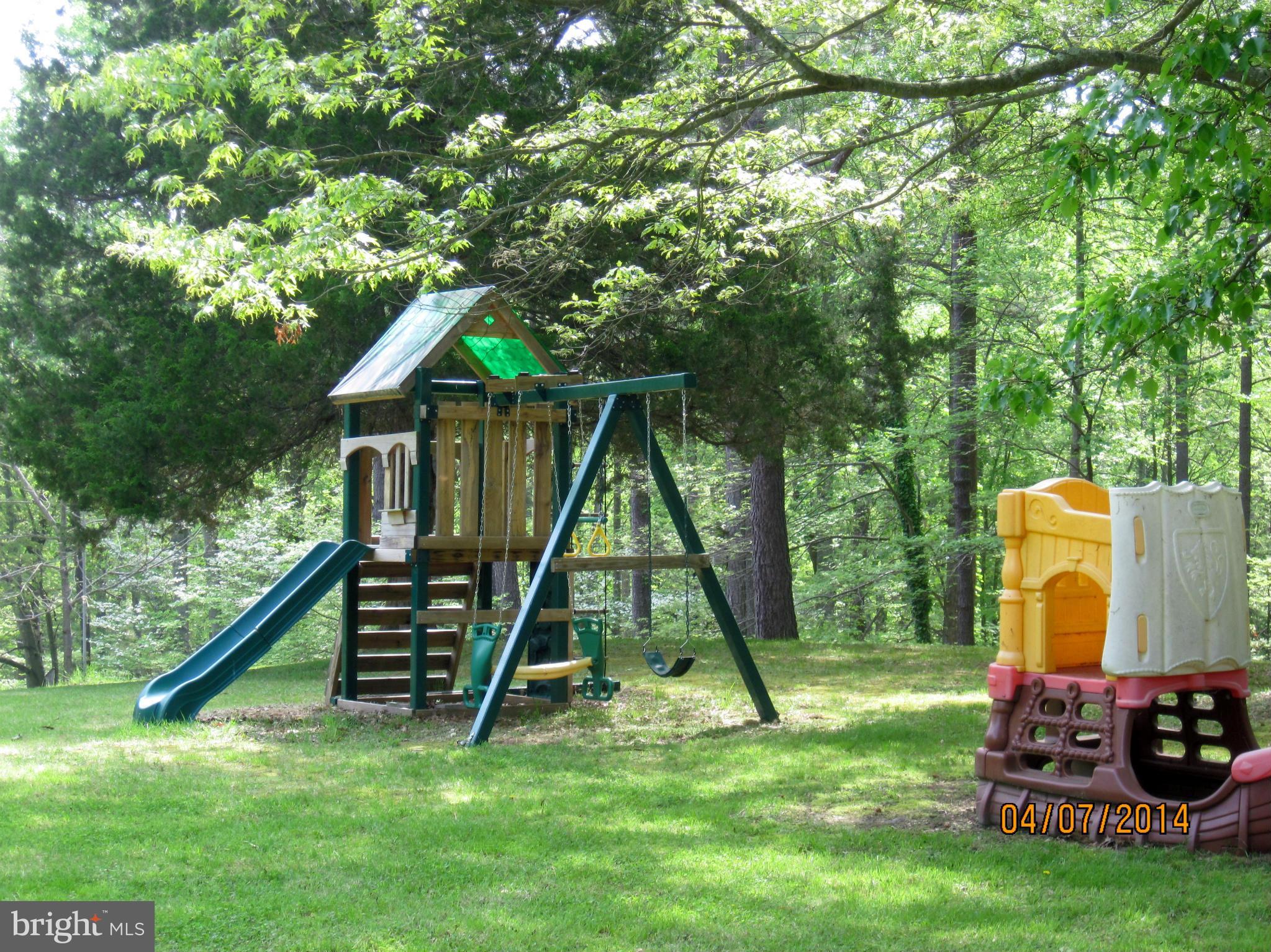 7151 Marshall Road St. Leonard, MD 20685 - Photo 6 of 25 a view of backyard with a slide and a wooden bench