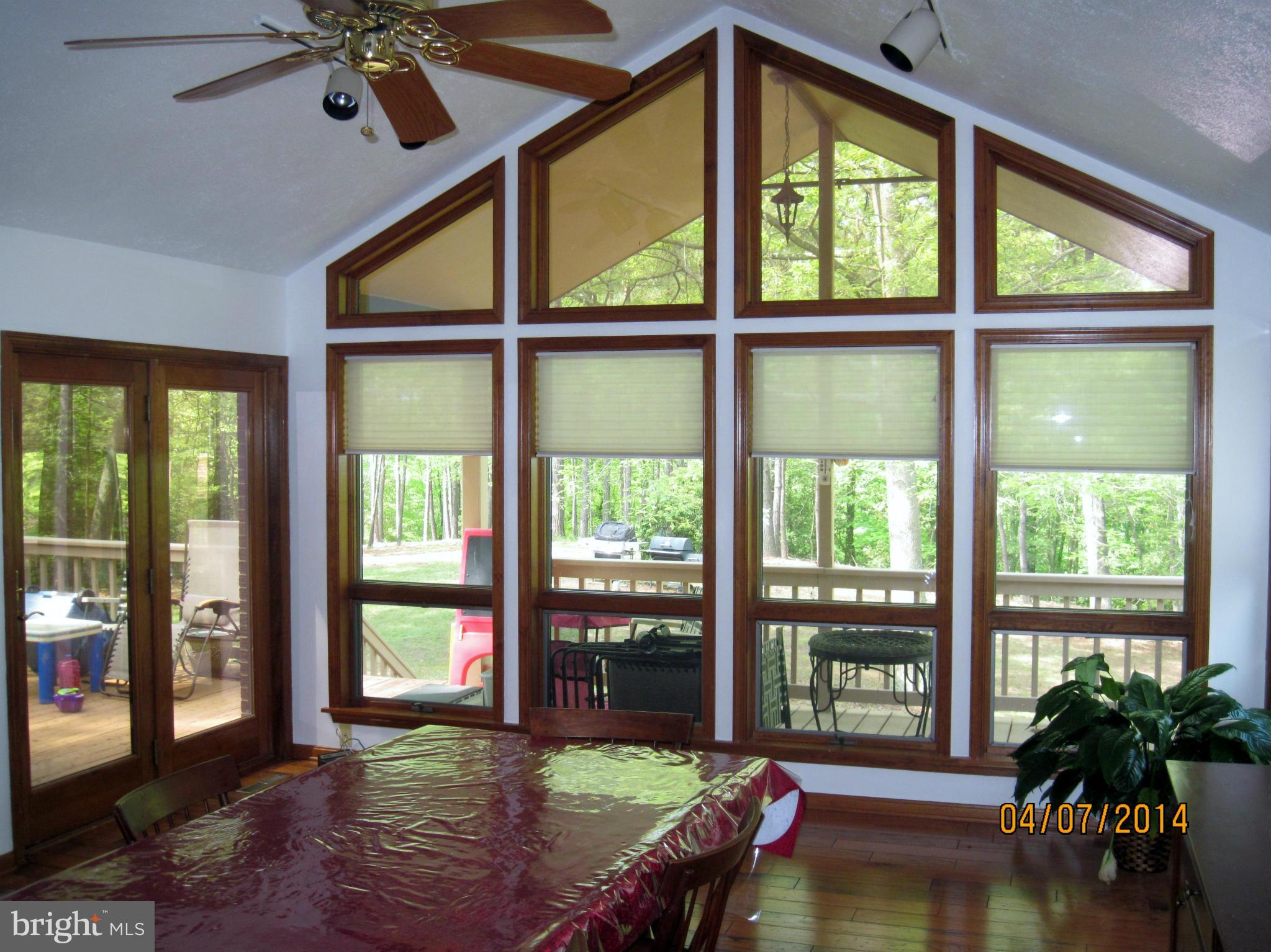 7151 Marshall Road St. Leonard, MD 20685 - Photo 8 of 25 a living room with hardwood floor and a floor to ceiling window