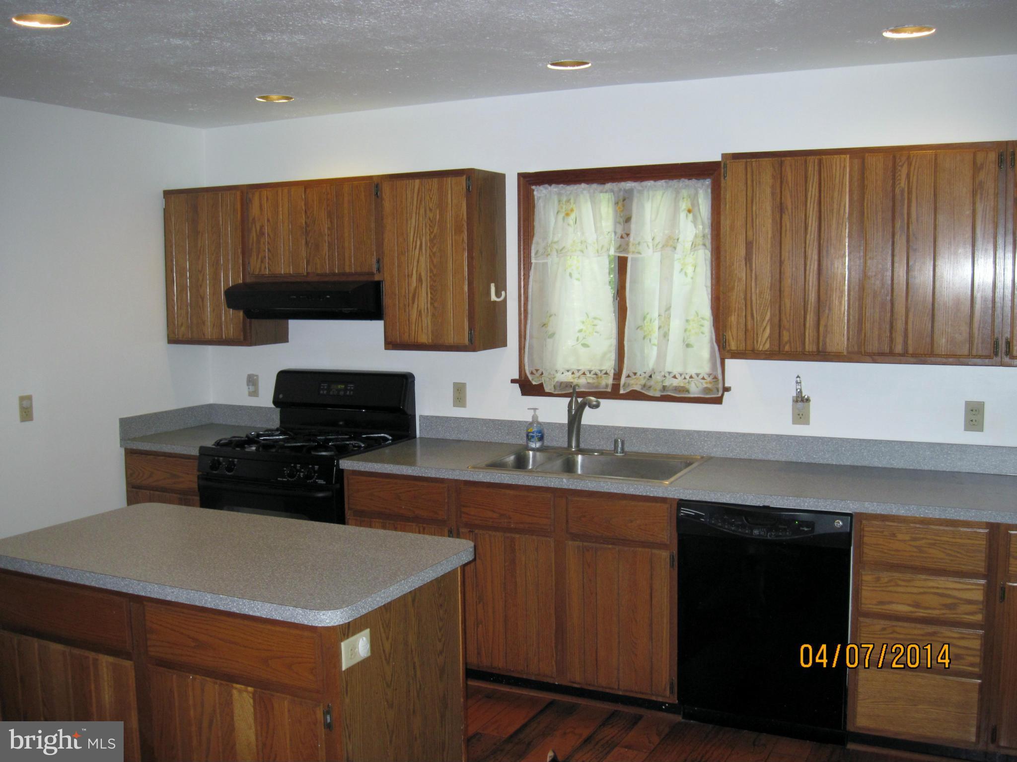 7151 Marshall Road St. Leonard, MD 20685 - Photo 9 of 25 a kitchen with a sink dishwasher a stove and a microwave oven