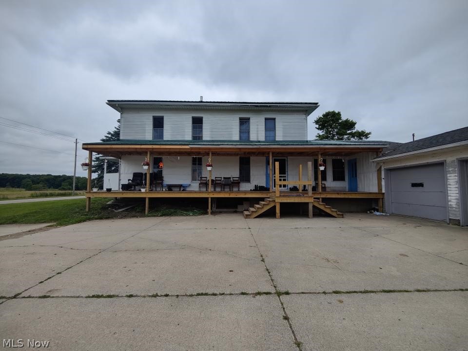 6297 Leon Road Andover, OH 44003 - Photo 20 of 20 Farmhouse with a garage and a porch