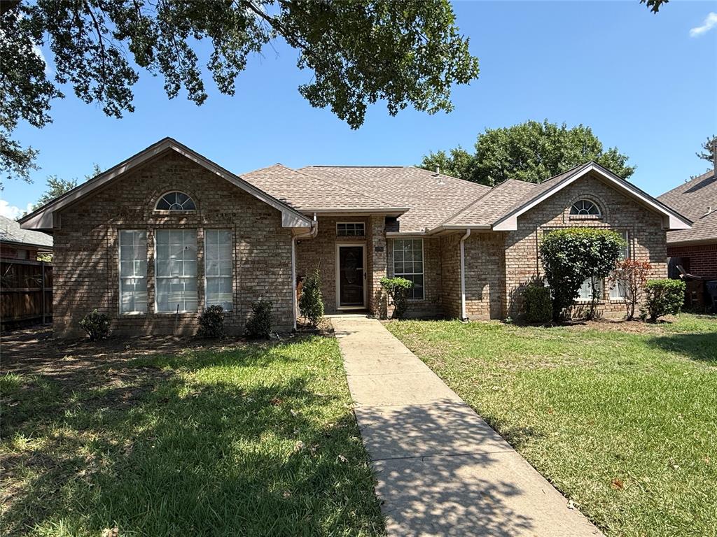 313 Pear Tree Place Denton, TX 76207 - Photo 1 of 23 Ranch-style house featuring roof with shingles, brick siding, and a front lawn
