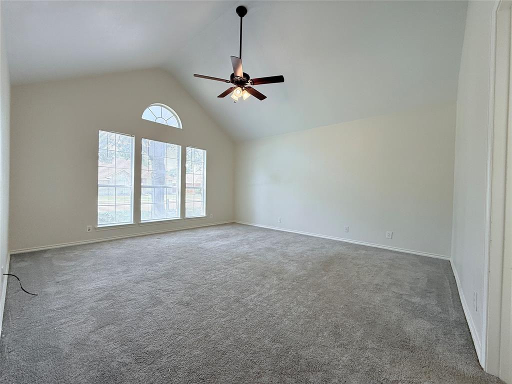 313 Pear Tree Place Denton, TX 76207 - Photo 13 of 23 Unfurnished room featuring high vaulted ceiling, light carpet, and ceiling fan