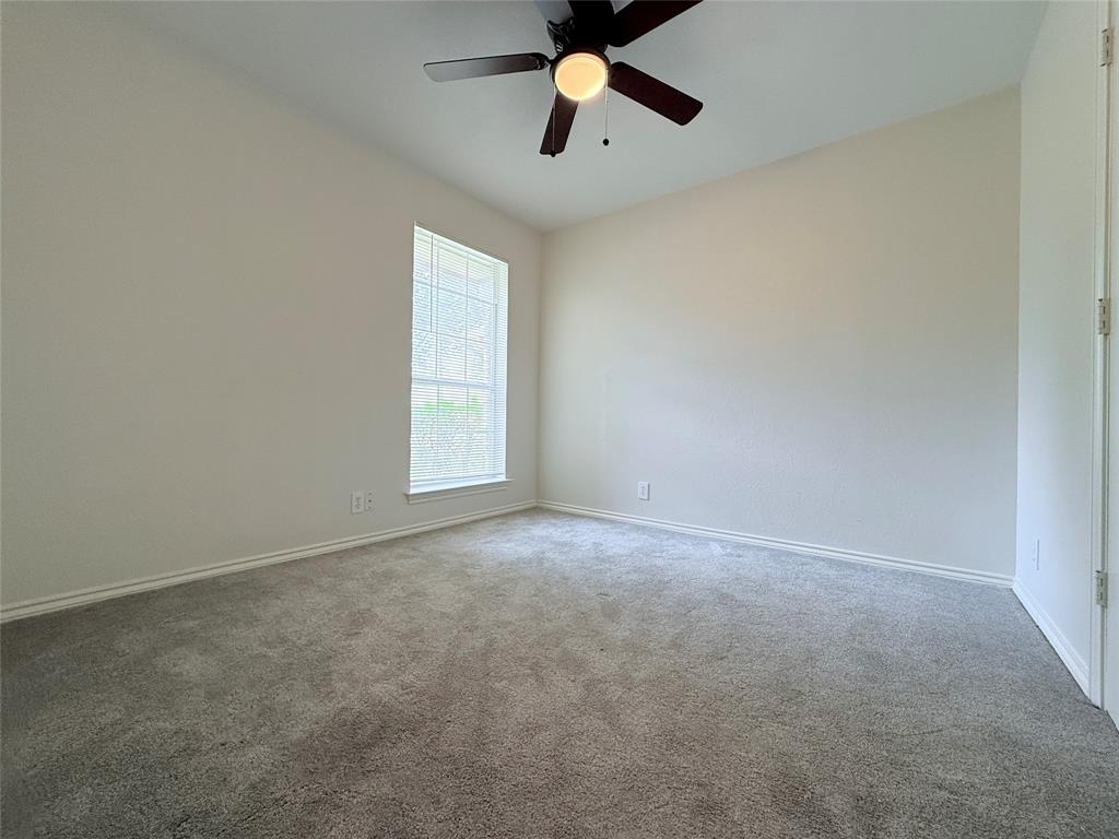 313 Pear Tree Place Denton, TX 76207 - Photo 18 of 23 Unfurnished room with carpet floors and a ceiling fan
