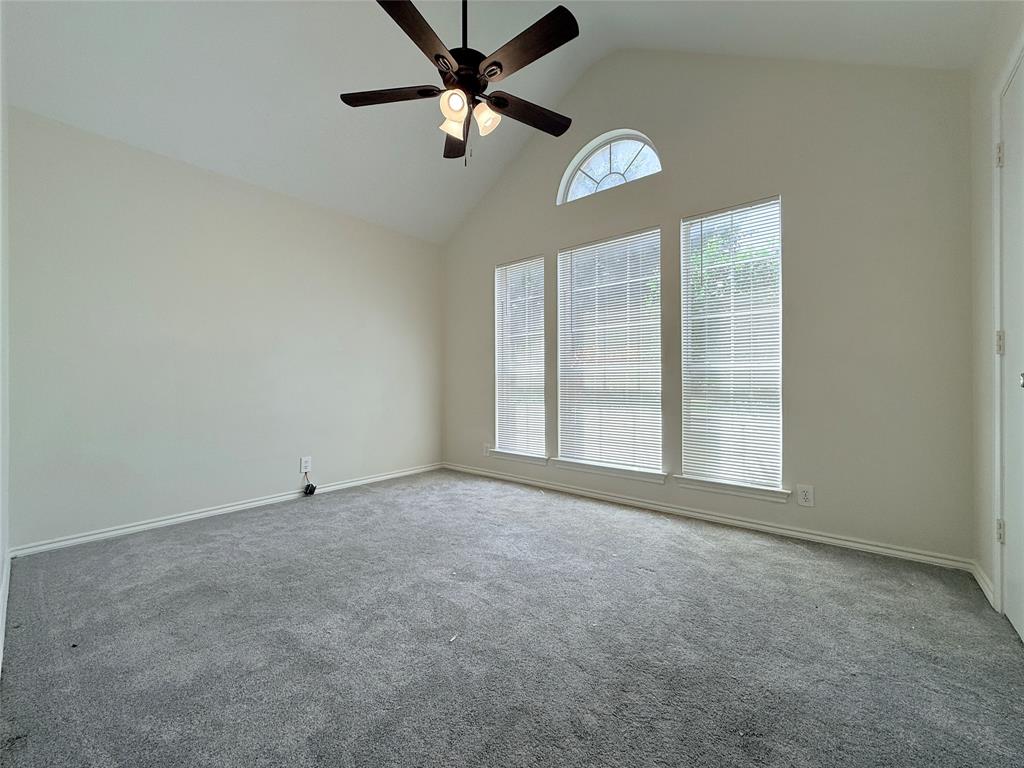 313 Pear Tree Place Denton, TX 76207 - Photo 19 of 23 Empty room featuring high vaulted ceiling, carpet flooring, and a ceiling fan
