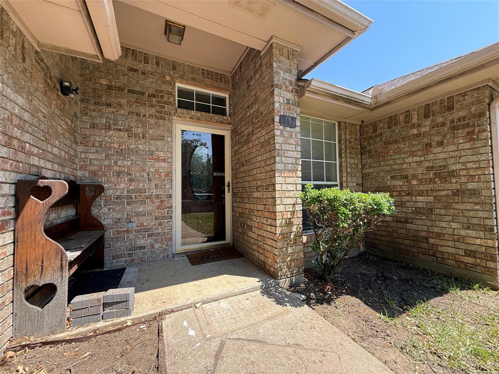 313 Pear Tree Place Denton, TX 76207 - Photo 2 of 23 Entrance to property with brick siding and a patio