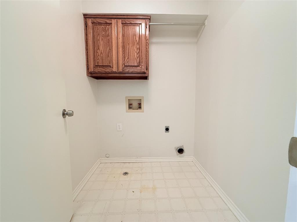 313 Pear Tree Place Denton, TX 76207 - Photo 21 of 23 Laundry area with washer hookup, cabinet space, hookup for an electric dryer, and light flooring