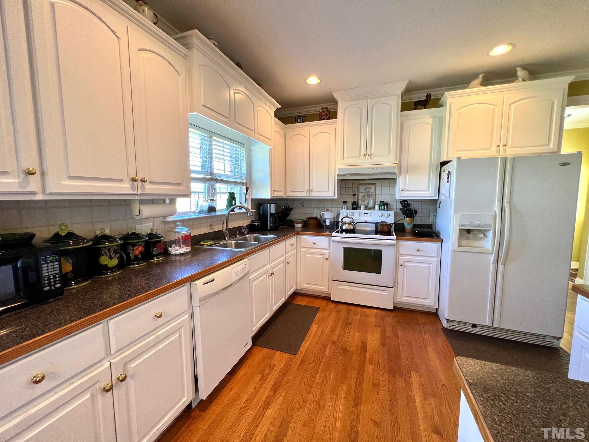 8666 Bailey Road Sims, NC 27880 - Photo 24 of 35 a kitchen with white cabinets and stainless steel appliances