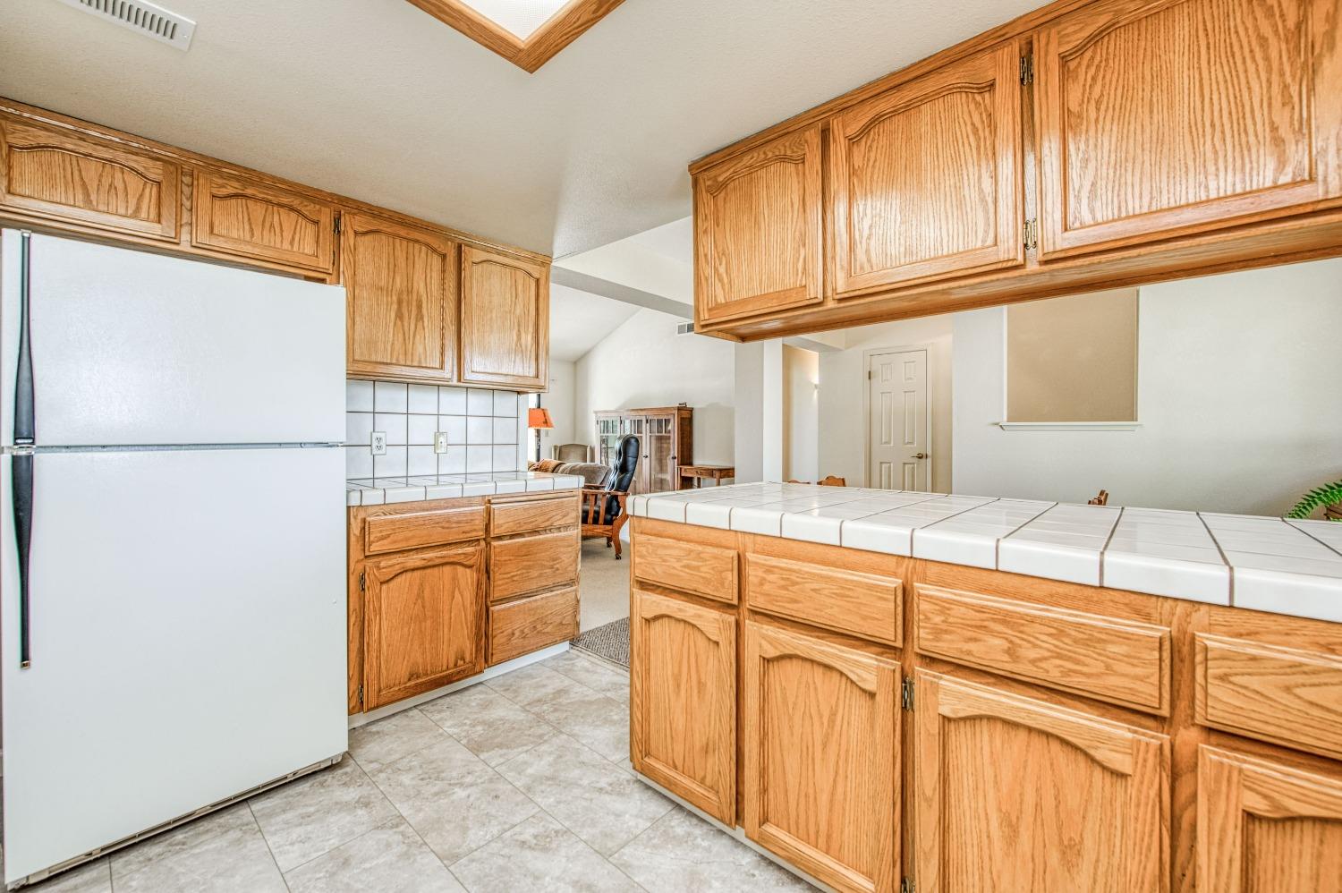 36730 Highway 145 Madera, CA 93636 - Photo 11 of 30 a kitchen with granite countertop cabinets and appliances