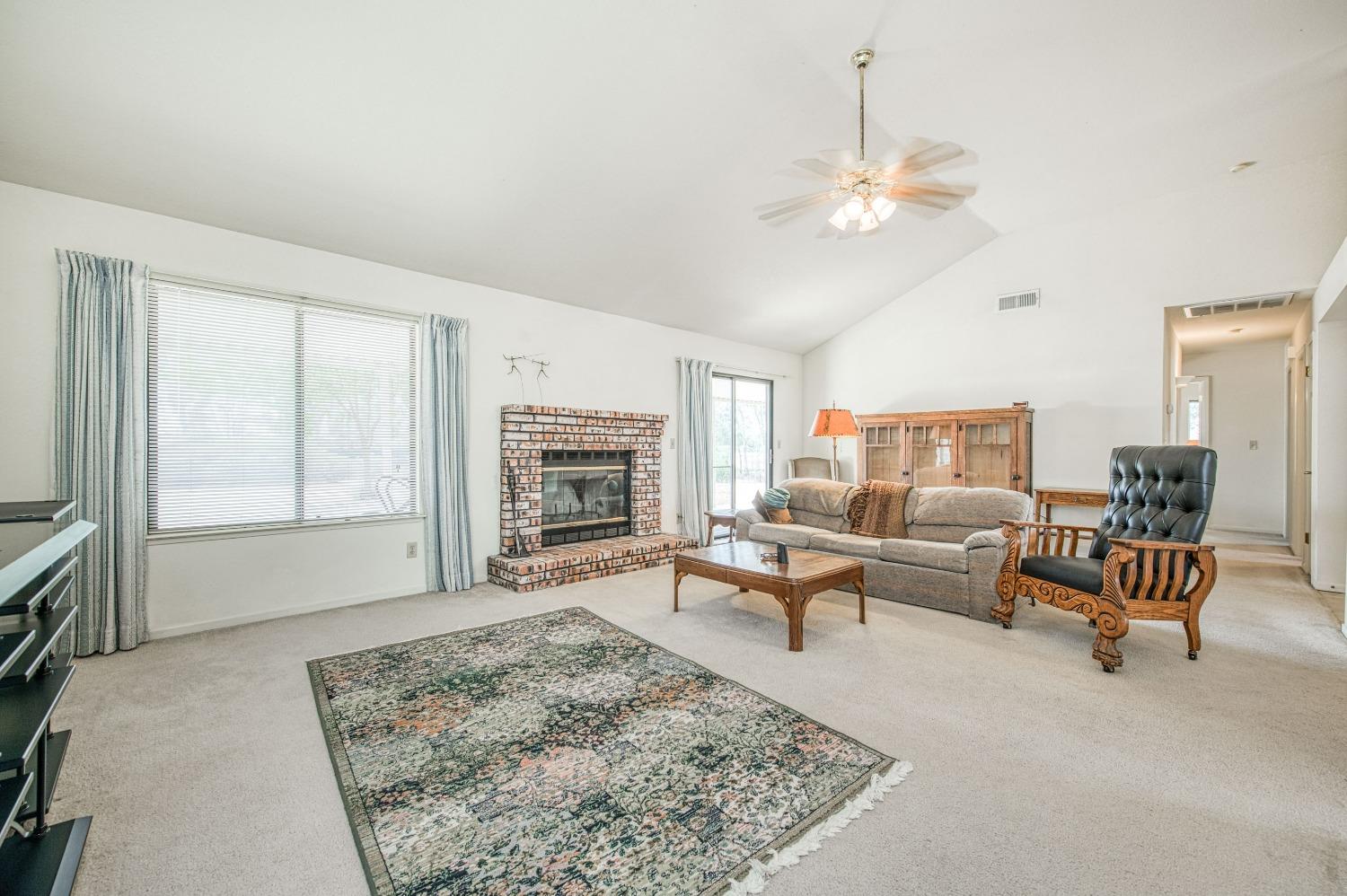 36730 Highway 145 Madera, CA 93636 - Photo 12 of 30 a living room with furniture and a fireplace