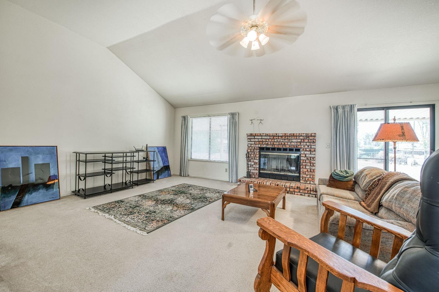 36730 Highway 145 Madera, CA 93636 - Photo 13 of 30 a living room with furniture or couch and a fireplace