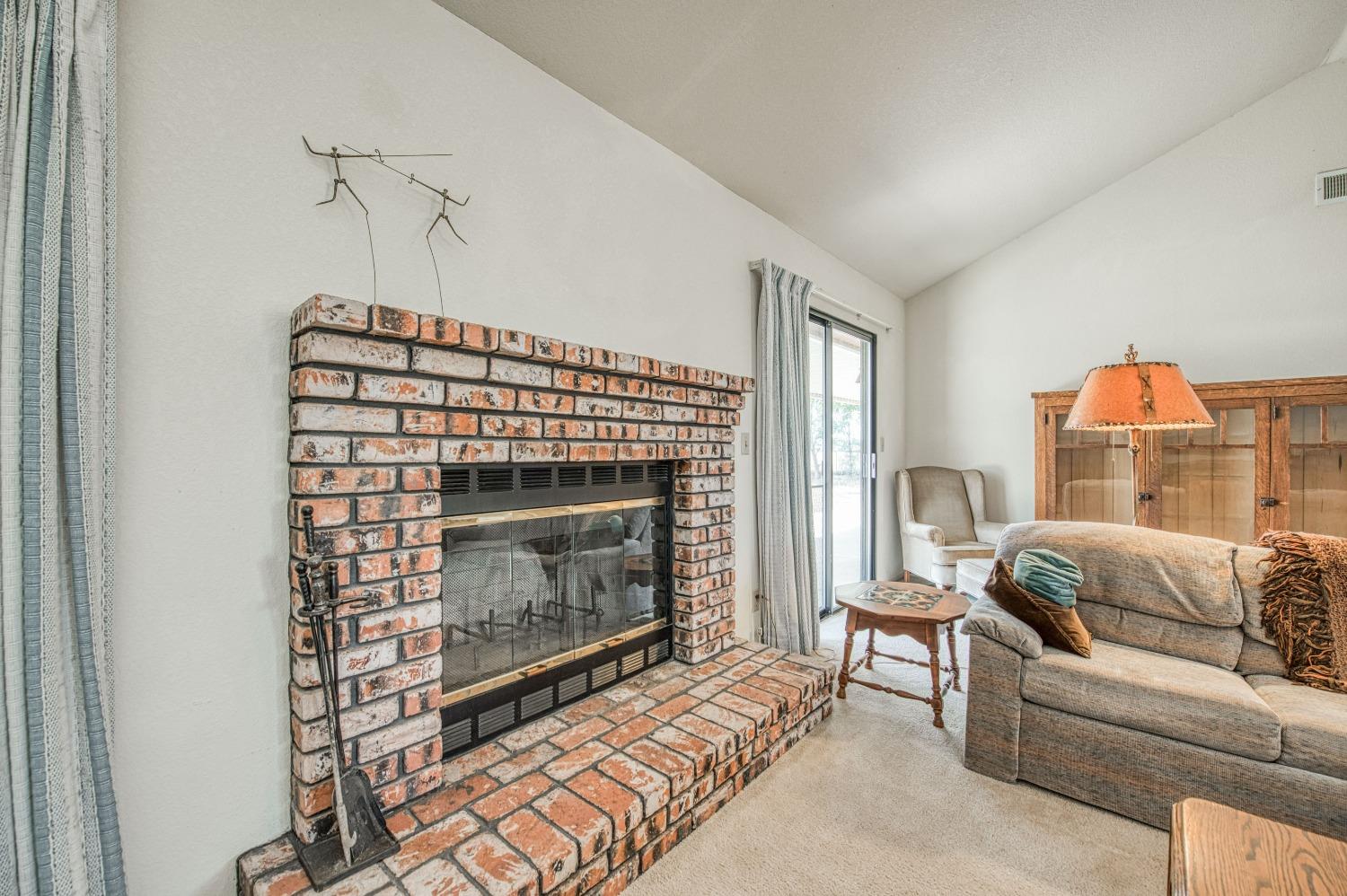 36730 Highway 145 Madera, CA 93636 - Photo 14 of 30 a living room with furniture a flat screen tv and a fireplace