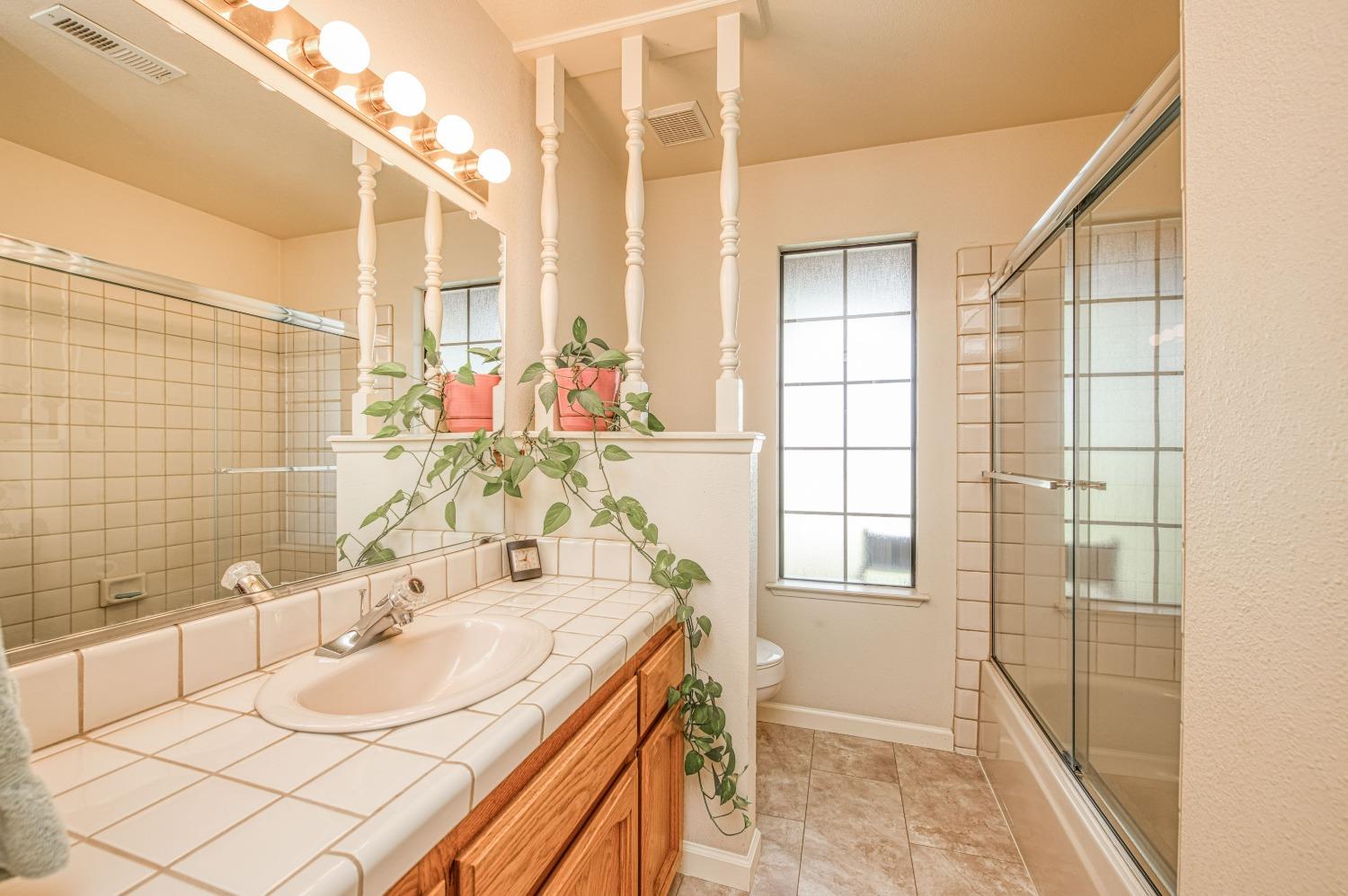 36730 Highway 145 Madera, CA 93636 - Photo 16 of 30 a bathroom with a sink and a mirror