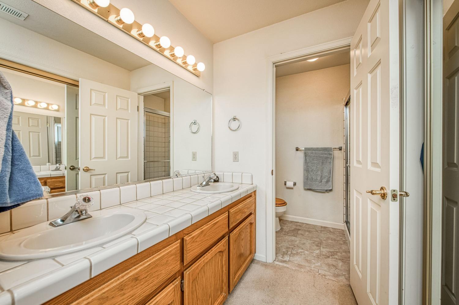 36730 Highway 145 Madera, CA 93636 - Photo 20 of 30 a spacious bathroom with a double vanity sink mirror and double