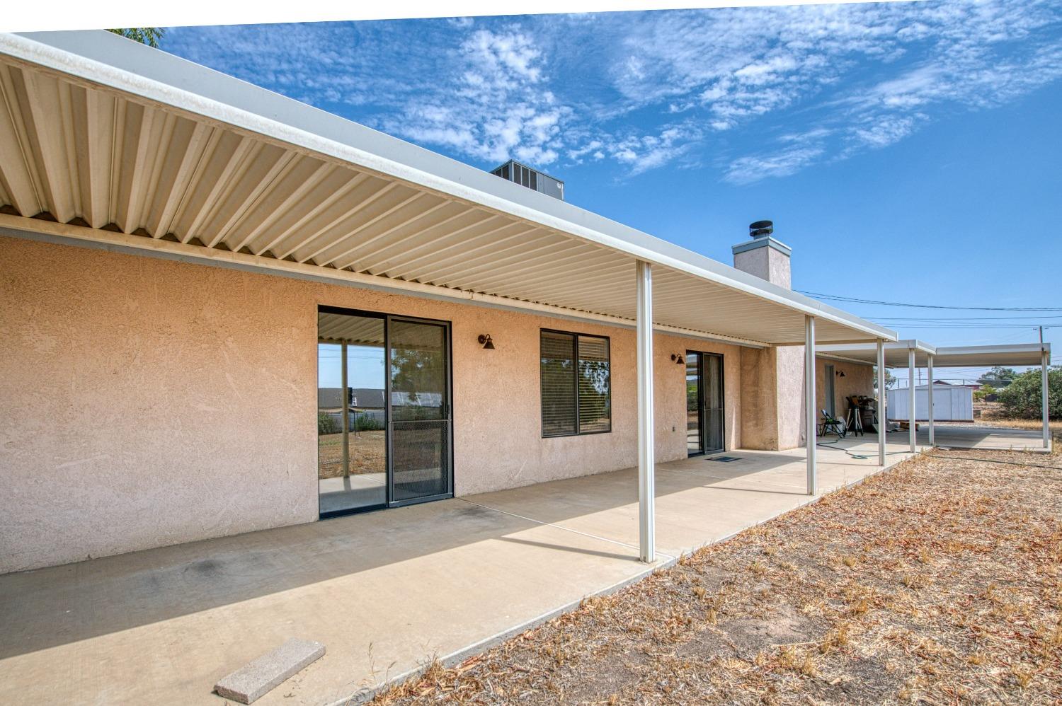 36730 Highway 145 Madera, CA 93636 - Photo 24 of 30 a front view of a house with a patio