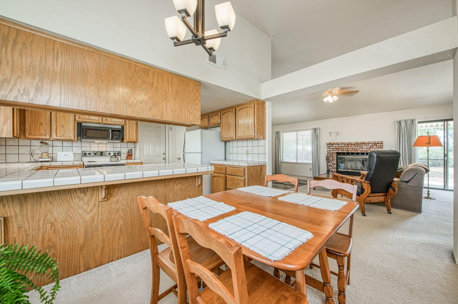 36730 Highway 145 Madera, CA 93636 - Photo 7 of 30 a dining table with chairs and kitchen view