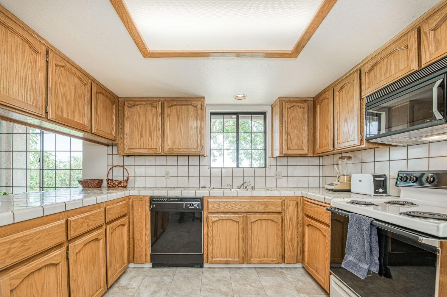36730 Highway 145 Madera, CA 93636 - Photo 9 of 30 a kitchen with stainless steel appliances granite countertop a sink stove cabinets wooden floor and granite counter top