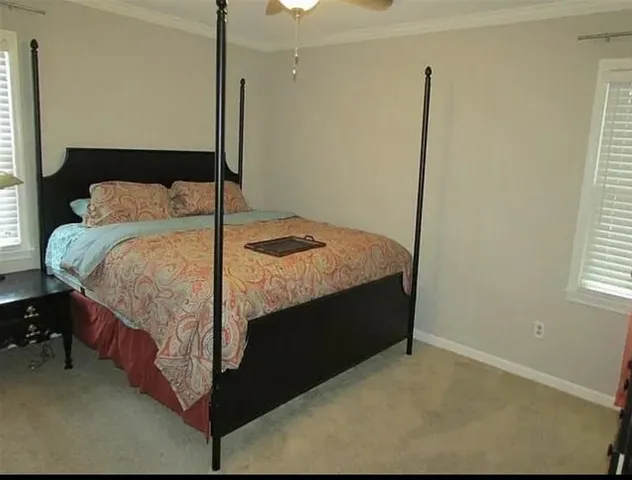 a bedroom with a bed and window