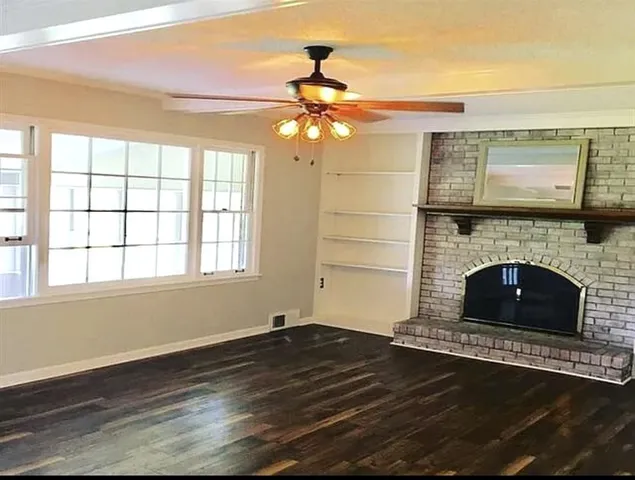 a living room with a fireplace and a flat screen tv