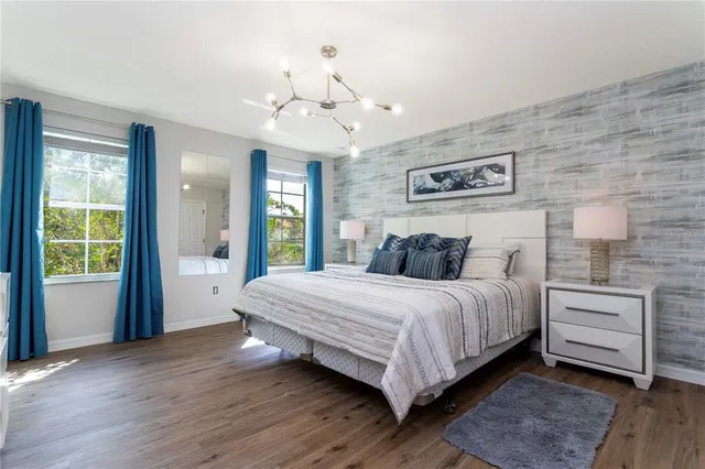 a view of bedroom with furniture and wooden floor