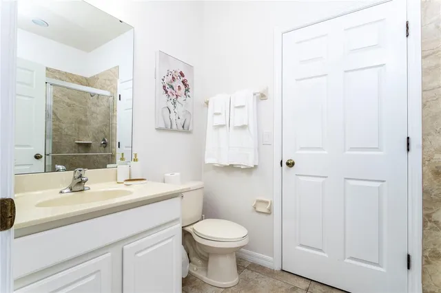 a kitchen with stainless steel appliances granite countertop a refrigerator a sink a stove a dining table and chairs