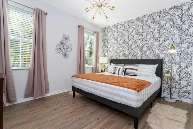 a living room with furniture kitchen view and a chandelier