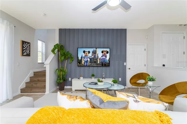 a living room with furniture and a flat screen tv