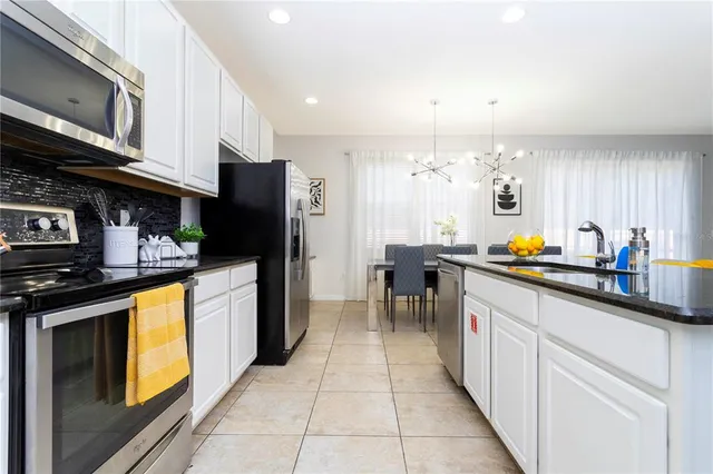 a living room with furniture a flat screen tv and a window