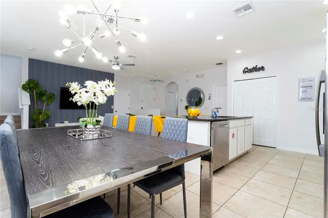 a living room with furniture and a dining table with kitchen view