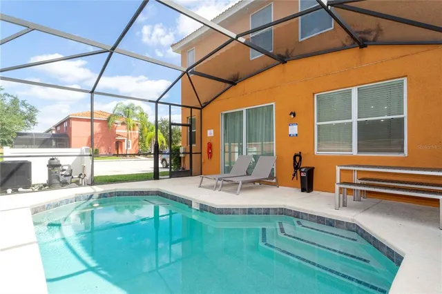 a swimming pool with outdoor seating and yard