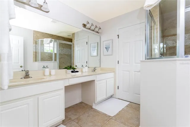 a bedroom with a bed window and a flat screen tv