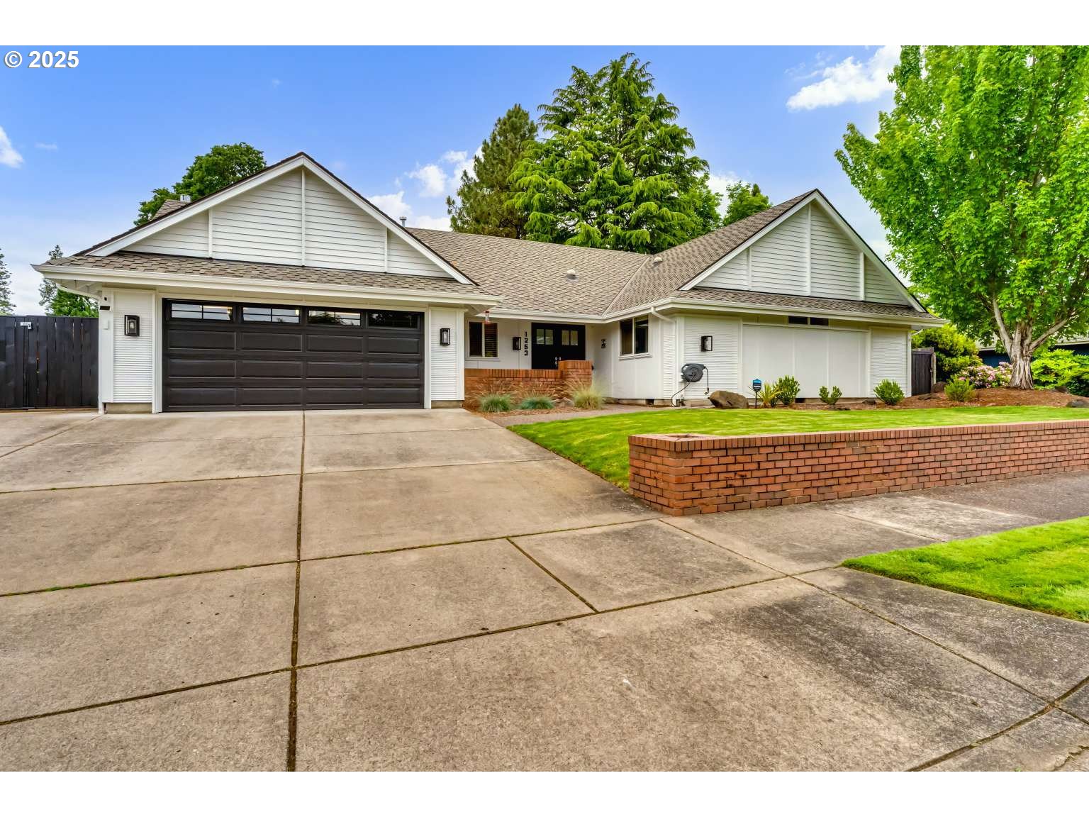 1253 Alfaretta Drive Eugene, OR 97401 - Photo 1 of 33 a front view of a house with a yard and garage