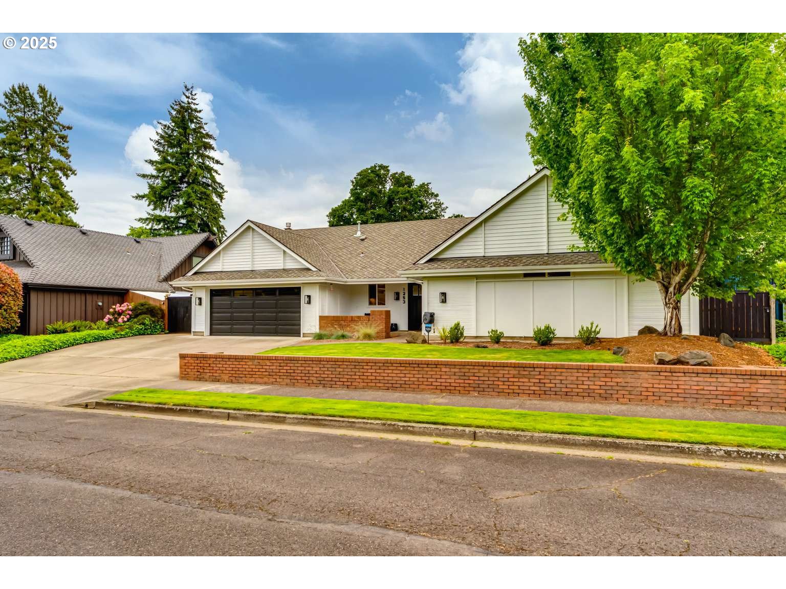 1253 Alfaretta Drive Eugene, OR 97401 - Photo 3 of 33 a view of a house with a big yard and large trees