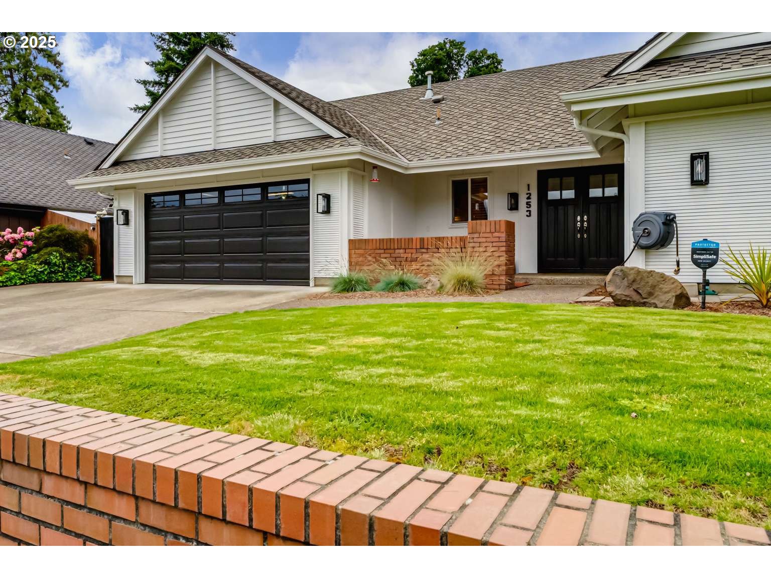 1253 Alfaretta Drive Eugene, OR 97401 - Photo 5 of 33 a front view of a house with a yard and garage