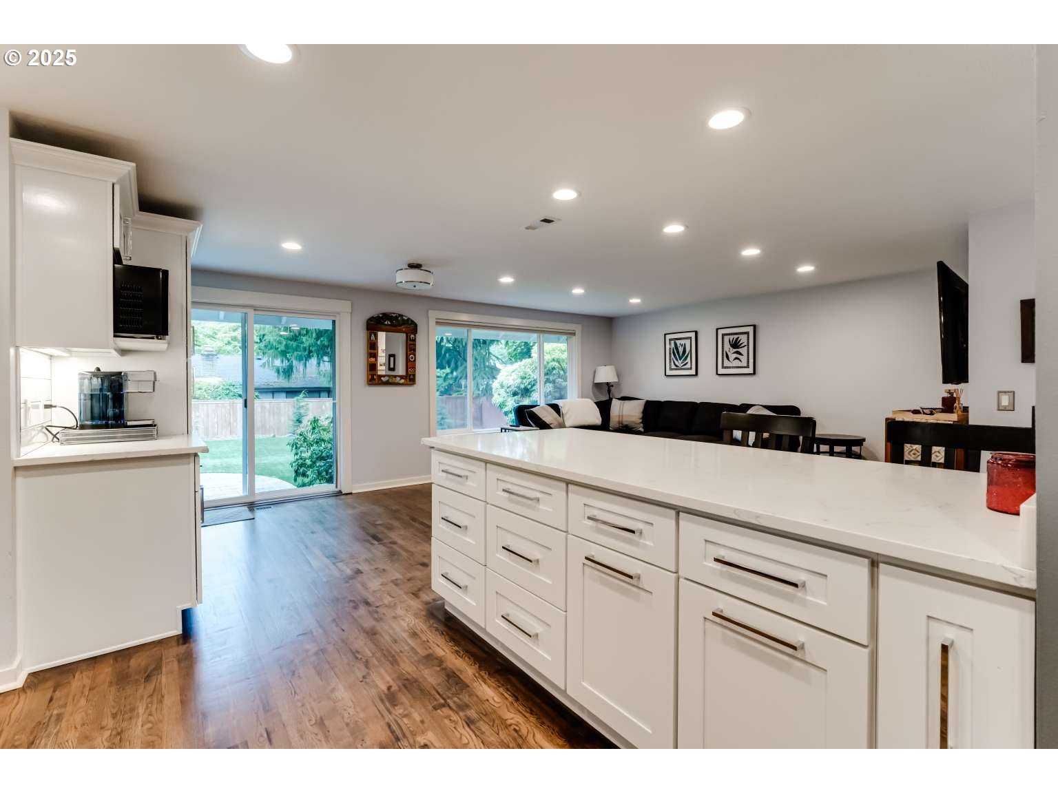 1253 Alfaretta Drive Eugene, OR 97401 - Photo 9 of 33 a open kitchen with kitchen island white cabinets and stainless steel appliances