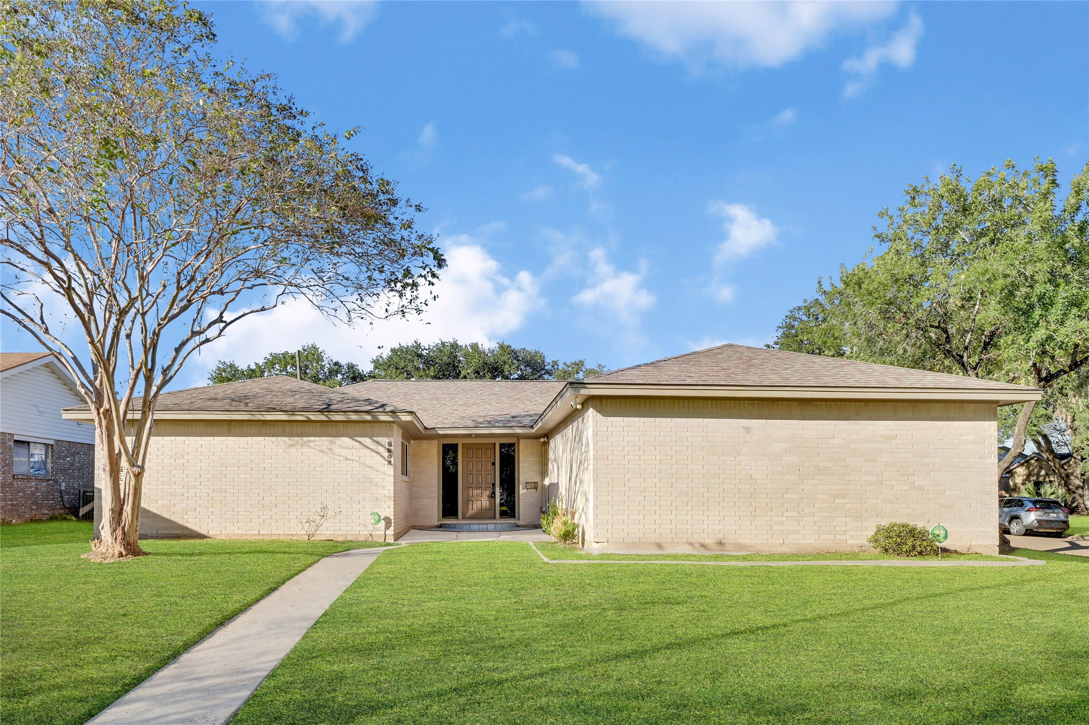 a view of house with outdoor space and garden