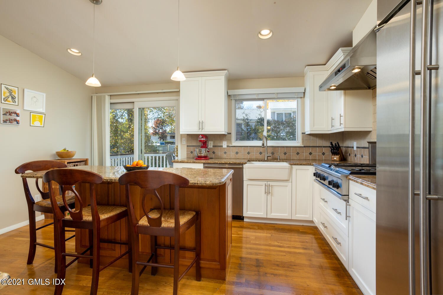89 Florence Road Riverside, CT 06878 - Photo 12 of 34 a kitchen with stainless steel appliances granite countertop table chairs sink and cabinets