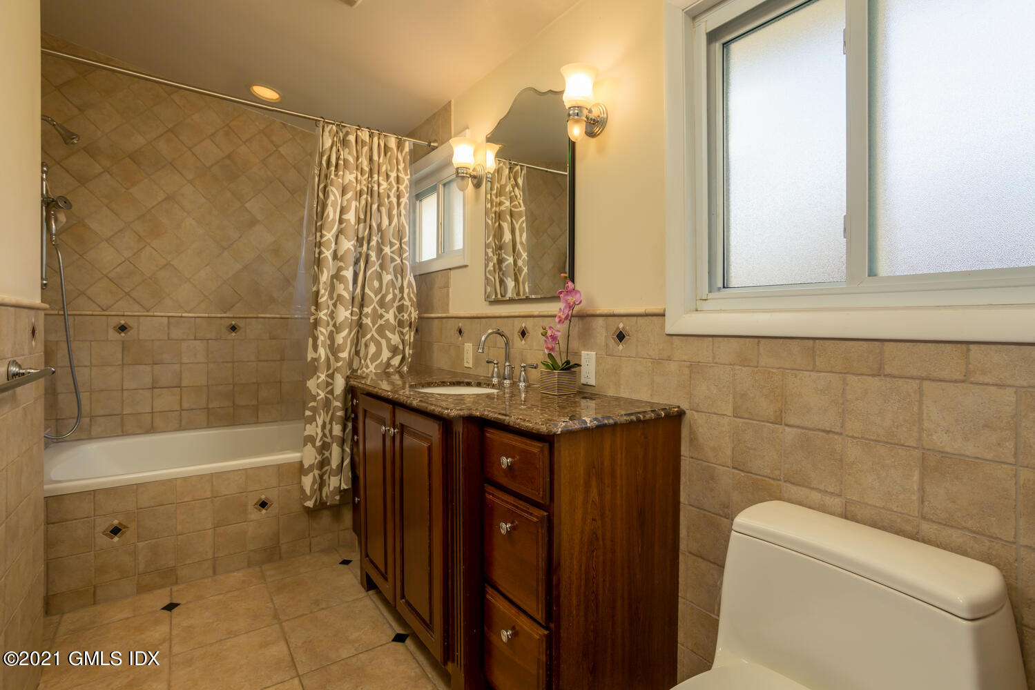 89 Florence Road Riverside, CT 06878 - Photo 19 of 34 a bathroom with a granite countertop sink a toilet and shower