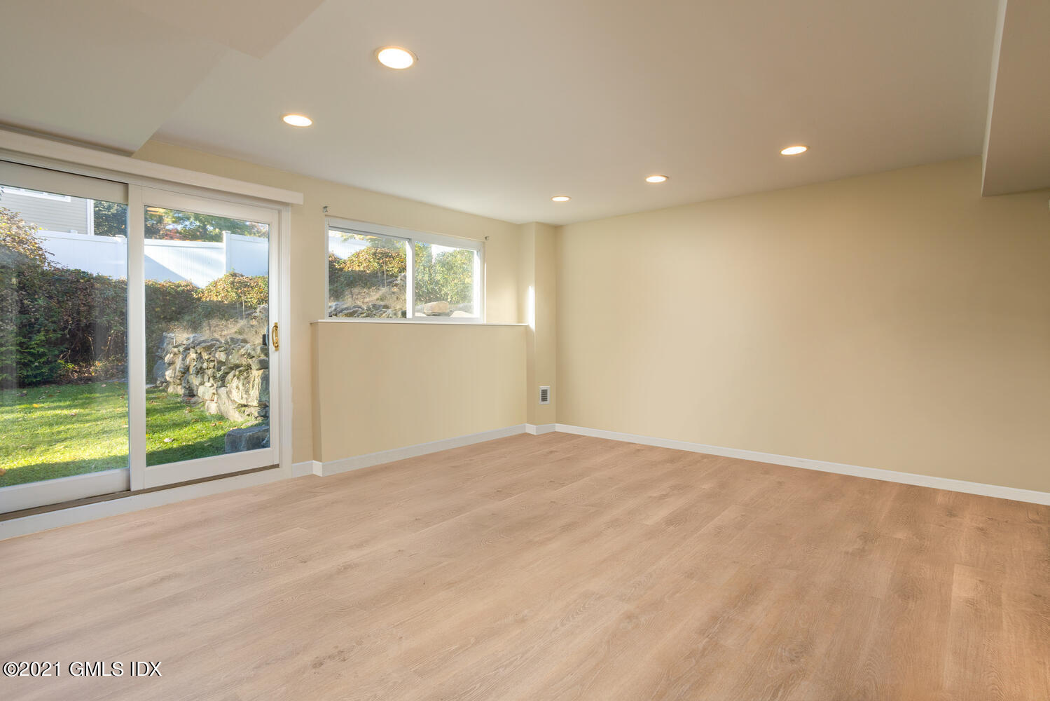 89 Florence Road Riverside, CT 06878 - Photo 21 of 34 a view of an empty room with wooden floor and a window
