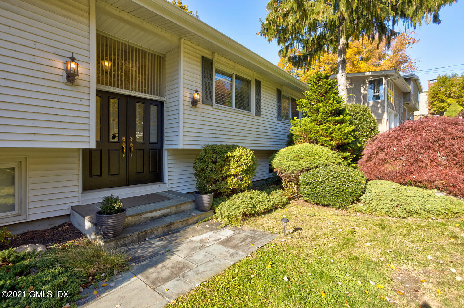 89 Florence Road Riverside, CT 06878 - Photo 3 of 34 a view of a house with potted plants and a large tree