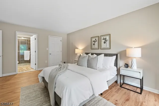 a bedroom with a bed and a night stand