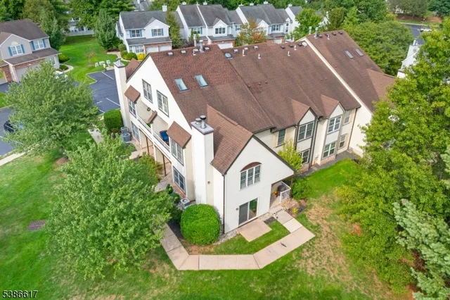 an aerial view of a house with swimming pool and garden