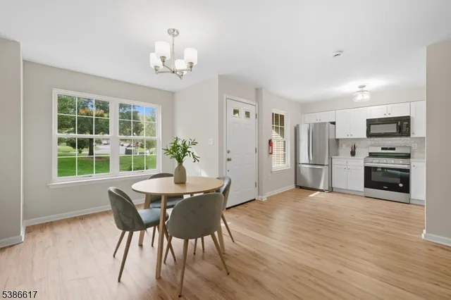a view of a dining room with furniture and a chandelier