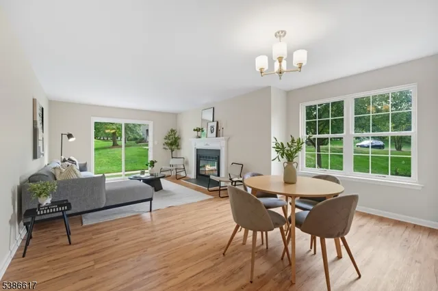 a living room with furniture a fireplace and a large window