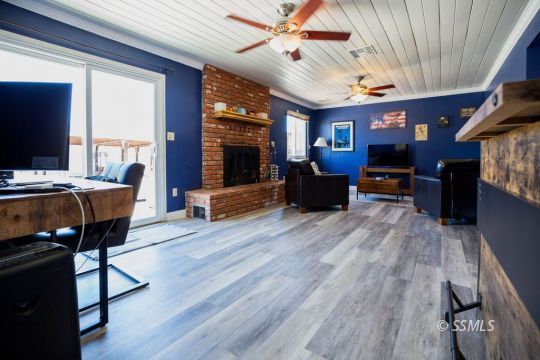 2030 South Inyo Street Ridgecrest, CA 93555 - Photo 15 of 42 a living room with furniture a fireplace and a flat screen tv