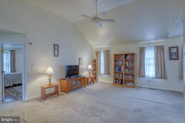 a view of a livingroom with furniture and a flat screen tv