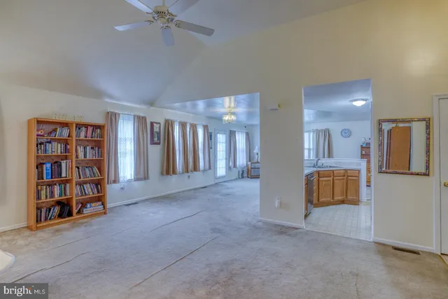 a view of an empty room with a cabinet and a window