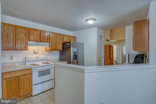 a kitchen with a sink stove and refrigerator